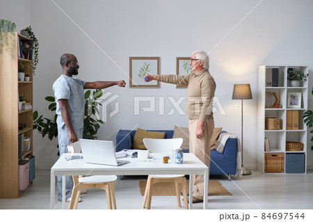 Elderly man holding rehabilitation after disease Elderly man holding rehabilitation after disease 84697544