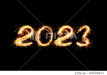 New Year 2023 light. Sparklers draw figures 2023. Bengal lights and letter New Year 2023 light. Sparklers draw figures 2023. Bengal lights and letter 84698015