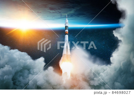 Rocket takes off into space with the planet. Spacecraft performs the space mission. Ship takes off into the starry sky. 84698027