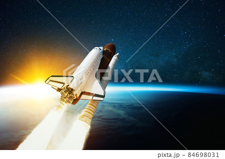 Space rocket flies in outer space with blue planet Earth and amazing sunset. Spaceship on a mission and is flying in cosmos with stars. Space travel concept and spacecraft lift off Space rocket flies in outer space with blue planet Earth and amazing sunset. Spaceship on a mission and is flying in cosmos with stars. Space travel concept and spacecraft lift off 84698031