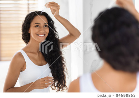 Skincare Concept. Beautiful Young Woman Applying Face Serum With Dropper In Bathroom Skincare Concept. Beautiful Young Woman Applying Face Serum With Dropper In Bathroom 84698865
