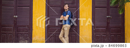 BANNER, LONG FORMAT Man tourist on background of Hoi An ancient town, Vietnam. Vietnam opens to tourists again after quarantine Coronovirus COVID 19 84699863