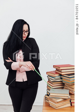 female teacher at the table with books for studying at the university female teacher at the table with books for studying at the university 84701051