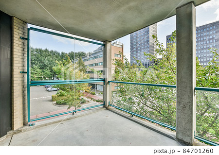 Large concrete balcony with glass railings and amazing view 84701260