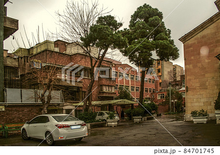 Cozy courtyard of the Church of St. Mary overlooking the brick facade of the Armenian school and the Museum of Decorative and Applied Arts in Tehran Cozy courtyard of the Church of St. Mary overlooking the brick facade of the Armenian school and the Museum of Decorative and Applied Arts in Tehran 84701745