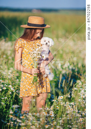 Happy child in field. Beautiful girl in dress in a straw hat Happy child in field. Beautiful girl in dress in a straw hat 84702298