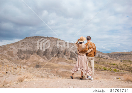 Happy couple on summer vacation in famous place. Cave formations in Cappadocia 84702714