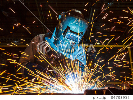 worker with protective mask welding metal 84703952