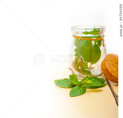 fresh mint leaves on a glass jar fresh mint leaves on a glass jar 84704368