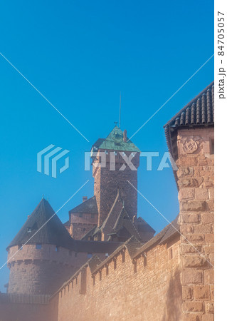 Haut Koenigsbourg fortified castle in the morning mist. Drawbridges, weapons room, keep and cannons, mountain fortress. Alsace, France, Europe. 84705057