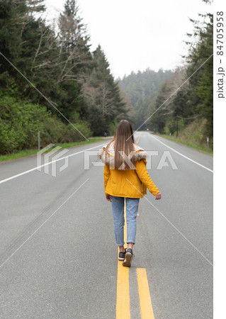 future concept. highway road among forest with walking girl. future concept. highway road among forest with walking girl. 84705958