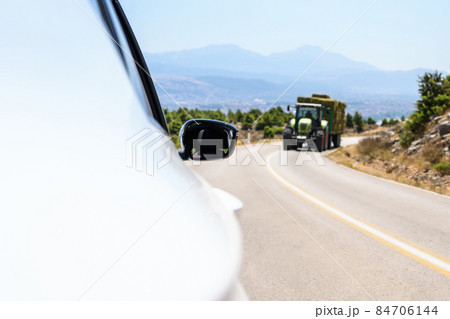 Car moving towards on the serpentine mountains road . 84706144