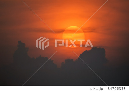 Sun disk through the clouds at sunset above the horizon. France. Sun disk through the clouds at sunset above the horizon. France. 84706333