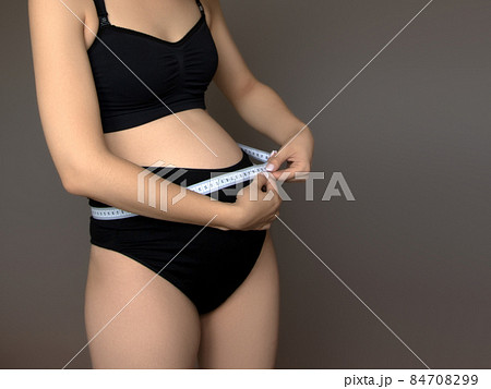 Beautiful pregnant young woman in clothes for 84708299