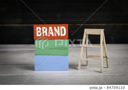 Brand, business development concept. Colored wooden blocks in a pile and stairs Brand, business development concept. Colored wooden blocks in a pile and stairs 84709110