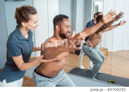 Young man receiving physical therapy on his shoulder 84709292