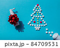 Creative Christmas tree made of pills on a blue background with nasal spray, prescription for sick 84709531