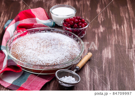 Swedish saffron Kladdkaka, pie with white chocolate, whipping cream and cranberry, horizontal 84709997