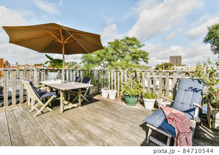 Exterior of the roof of the house with a delightful design with comfortable sun loungers and a table Exterior of the roof of the house with a delightful design with comfortable sun loungers and a table 84710544
