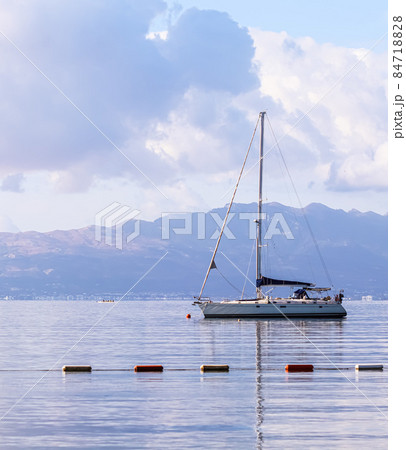 Blue sea, a boat and mountains in sunrise. Tranquil seascape and coastal nature concept 84718828