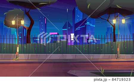 City street with park behind fence at night City street with park behind fence at night 84719323