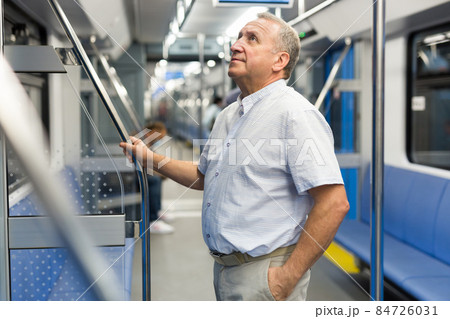 Middle aged man in subway car 84726031