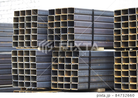 Metal profile pipe of rectangular cross section in packs at the warehouse of metal products Metal profile pipe of rectangular cross section in packs at the warehouse of metal products 84732660