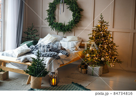 Stylish living room interior with decorated Christmas tree Stylish living room interior with decorated Christmas tree 84734816