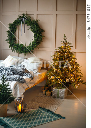 Stylish living room interior with decorated Christmas tree 84734817