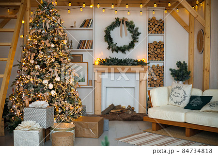 Stylish living room interior with decorated Christmas tree Stylish living room interior with decorated Christmas tree 84734818