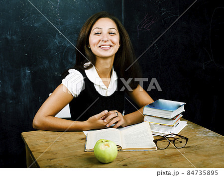 portrait of happy cute real teen student in classroom at blackboard, lifestyle people concept portrait of happy cute real teen student in classroom at blackboard, lifestyle people concept 84735895