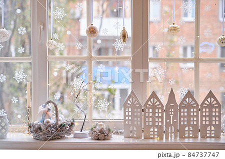 winter decor on windowsill with decor, basket with Christmas balls 84737747