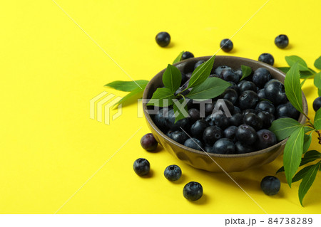 Fresh berry concept with blueberry on yellow background Fresh berry concept with blueberry on yellow background 84738289