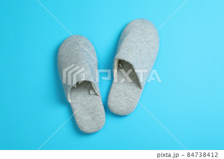 Pair of house slippers on blue background Pair of house slippers on blue background 84738412