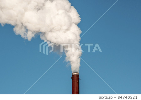 Thick and heavy smoke coming out of a rusty chimney Thick and heavy smoke coming out of a rusty chimney 84740521