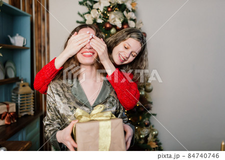Lesbian couple together indoors cheerfully communicate, preparing for celebration of Christmas. 84740746