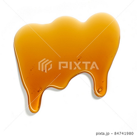 flowing sugar syrup on white background 84741980