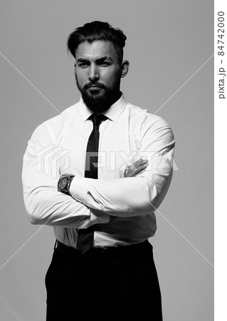 Man in elegant clothes on gray backdrop Man in elegant clothes on gray backdrop 84742000