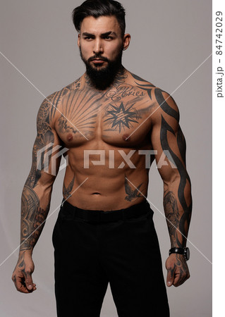 Muscular shirtless tattooed guy in studio Muscular shirtless tattooed guy in studio 84742029