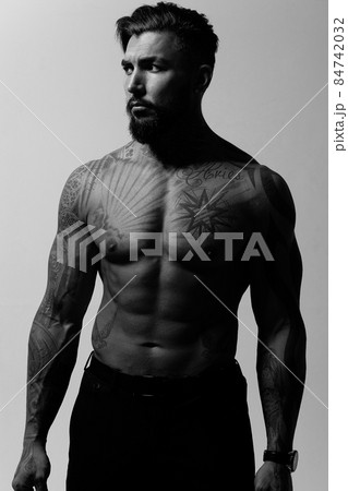 Muscular shirtless tattooed guy in studio Muscular shirtless tattooed guy in studio 84742032