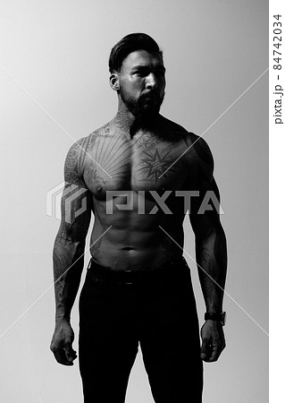 Muscular shirtless tattooed guy in studio Muscular shirtless tattooed guy in studio 84742034