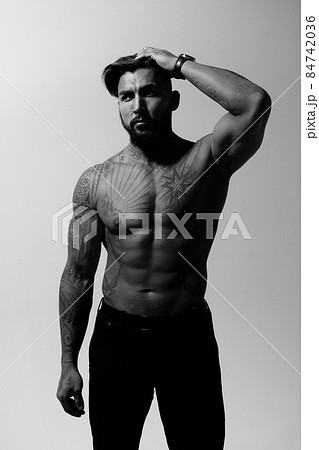 Muscular shirtless tattooed guy in studio Muscular shirtless tattooed guy in studio 84742036