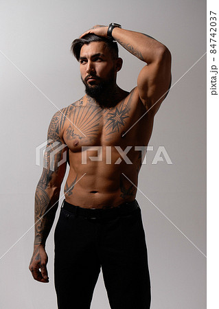 Muscular shirtless tattooed guy in studio Muscular shirtless tattooed guy in studio 84742037