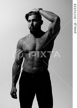 Muscular shirtless tattooed guy in studio Muscular shirtless tattooed guy in studio 84742038
