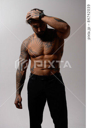 Muscular shirtless tattooed guy in studio Muscular shirtless tattooed guy in studio 84742039