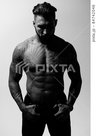 Muscular shirtless tattooed guy in studio Muscular shirtless tattooed guy in studio 84742046