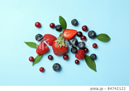 Delicious fresh berry mix on blue background 84742122