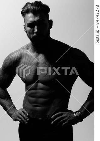 Muscular shirtless tattooed guy in studio Muscular shirtless tattooed guy in studio 84742273