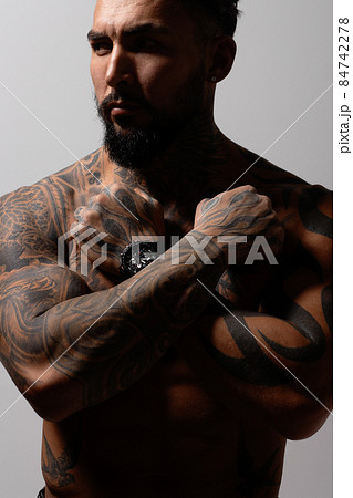 Muscular shirtless tattooed guy in studio Muscular shirtless tattooed guy in studio 84742278