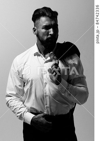 Man in elegant clothes on gray backdrop Man in elegant clothes on gray backdrop 84742336